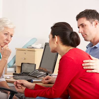 A patient, her partner, and her doctor talking