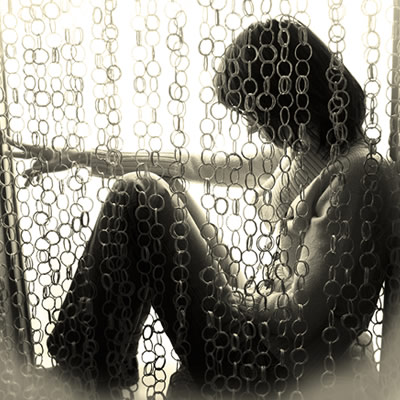 woman sitting in window; sadness