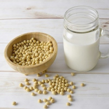 bowl of soybeans and a glass of soymilk