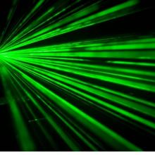 green beams of light on a black background