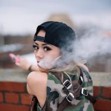 young woman using e-cigarette